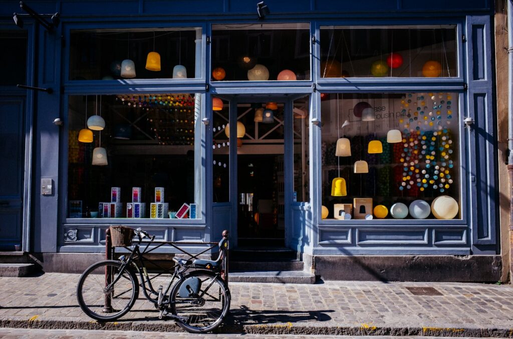 Shop front on a cobbled street with a bicycle parked outside