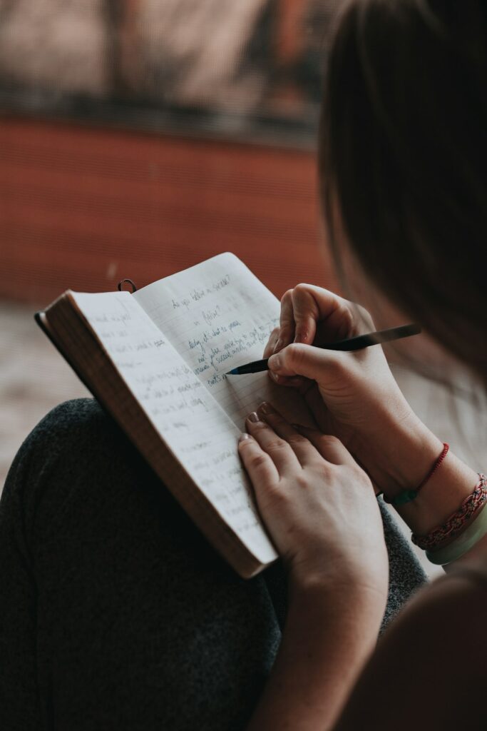 Person writing notes in a notebook